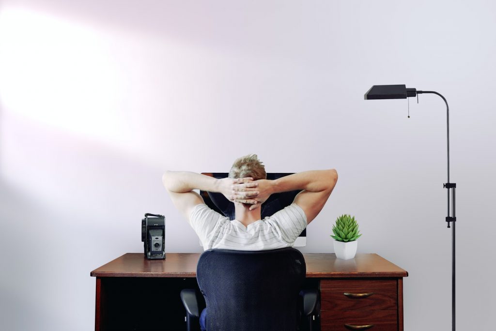 man thinking in front of computer